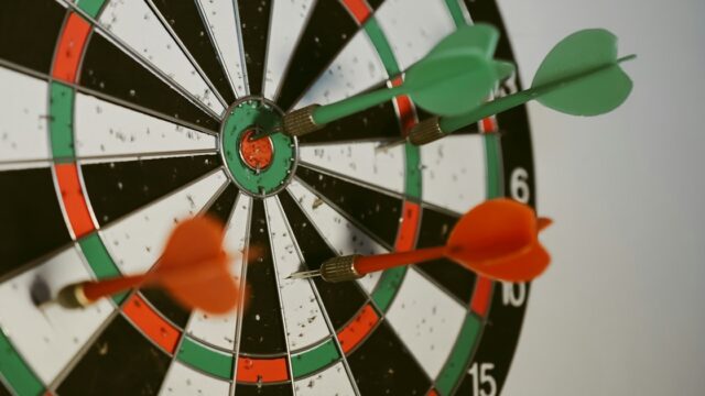 Darts schedule 2026–27: green and orange darts in a dartboard