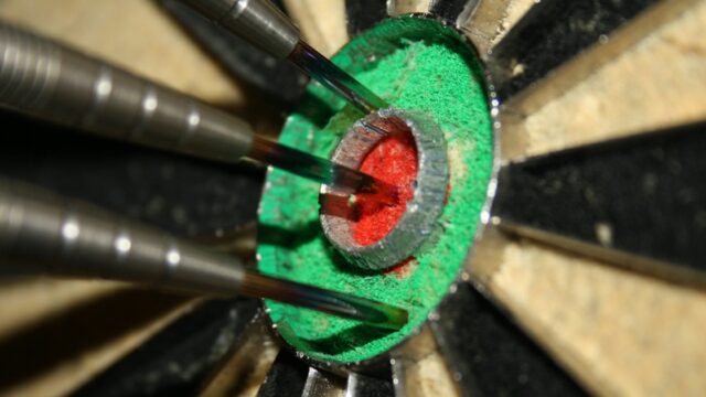 Grand Slam of Darts 2026 schedule: three darts in the bull of a dartboard
